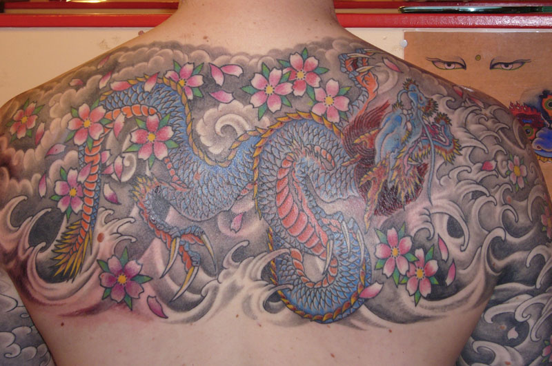 Blue Dragon with Waves and Flowers Tattoo